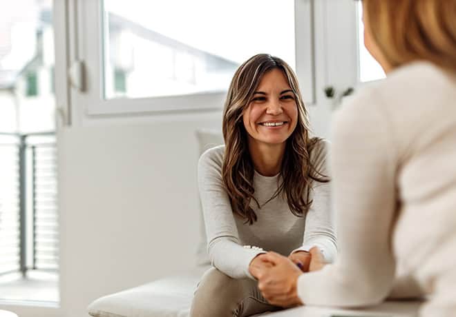 Smiling woman talking to counselor