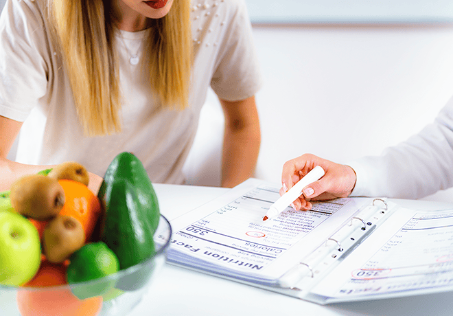 Nutritionist consulting with a patient as they view a nutrition label.