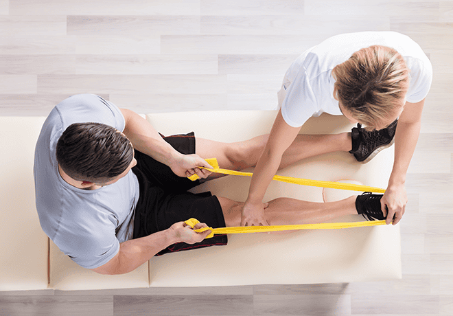 physical therapist helping a patient stretch